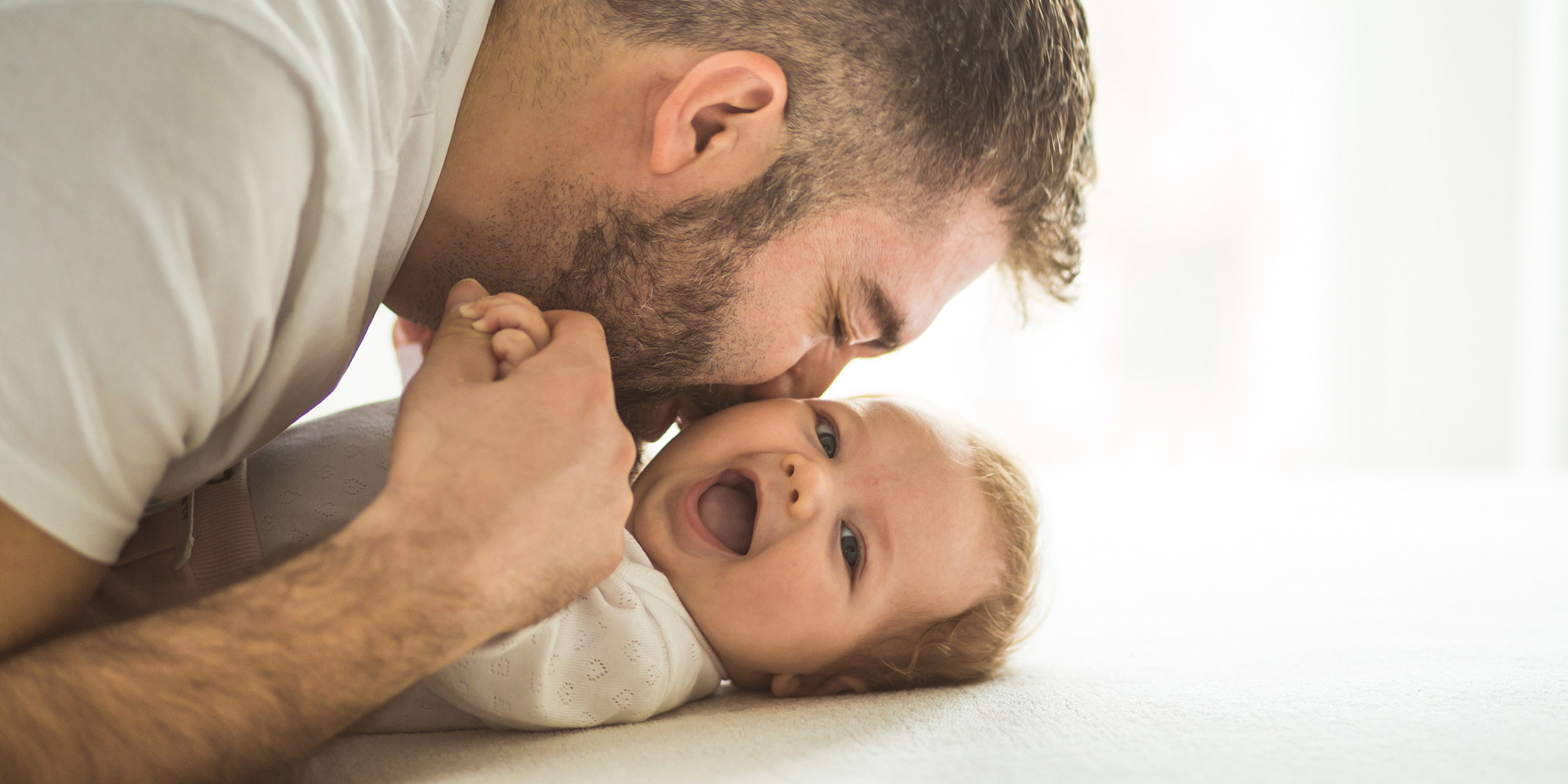 Dad playing with baby