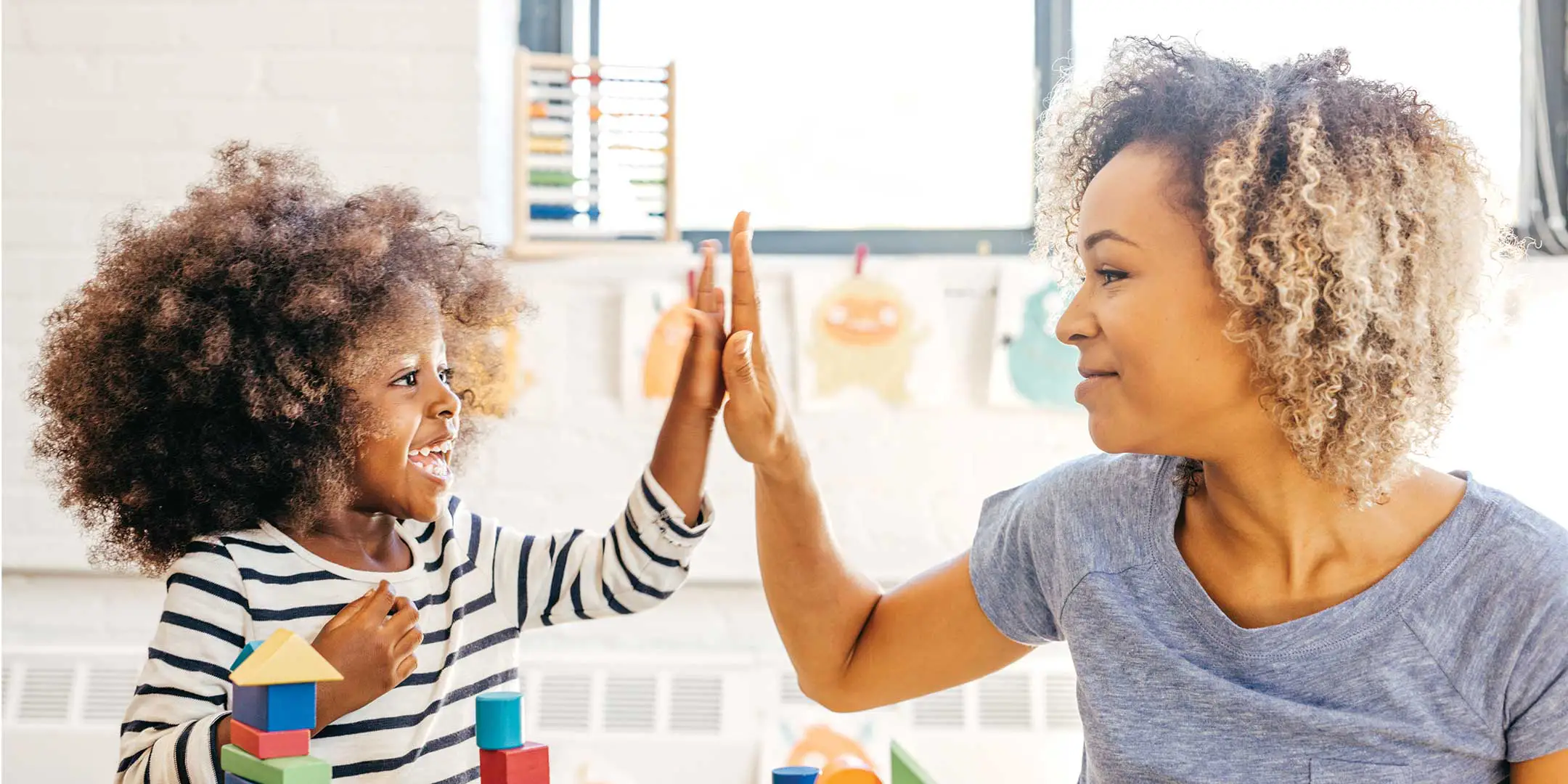 Kid and teacher giving a high five